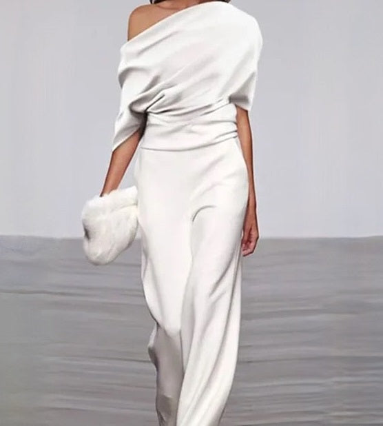 Timeless white summer jumpsuit for women, featuring an elegant design and comfortable wide legs. Ideal for holidays.