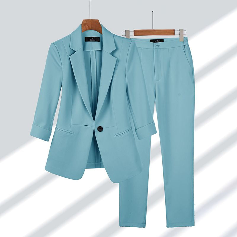 Chic women's two-piece suit: elegant blazer and trousers for versatile professional, formal, or workwear occasions.