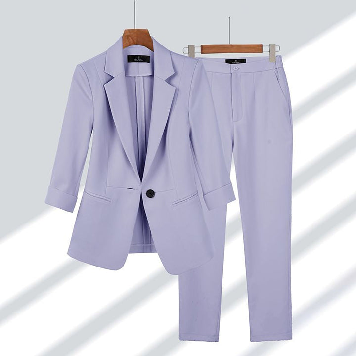 Professional women's blazer and trousers suit. A stylish two-piece set for business meetings, office, or formal events.