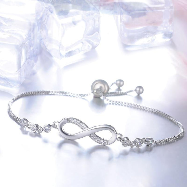 Timeless women's infinity bracelet, adjustable fit. Available in silver, gold, and rose gold. Elegant symbolic jewelry.
