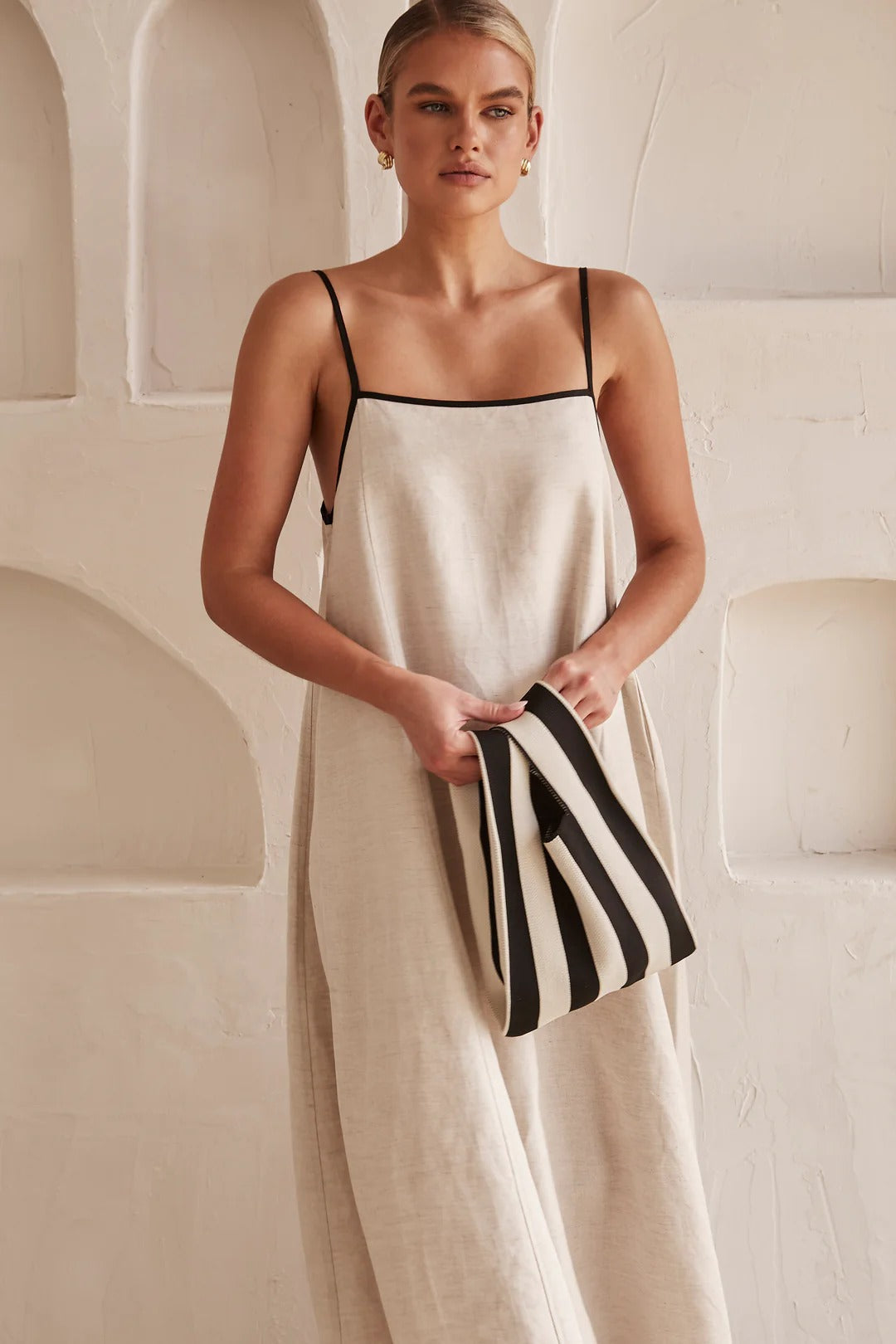 Chic women's beige summer midi dress, an elegant sleeveless and flowy option perfect for trendy warm-weather occasions.