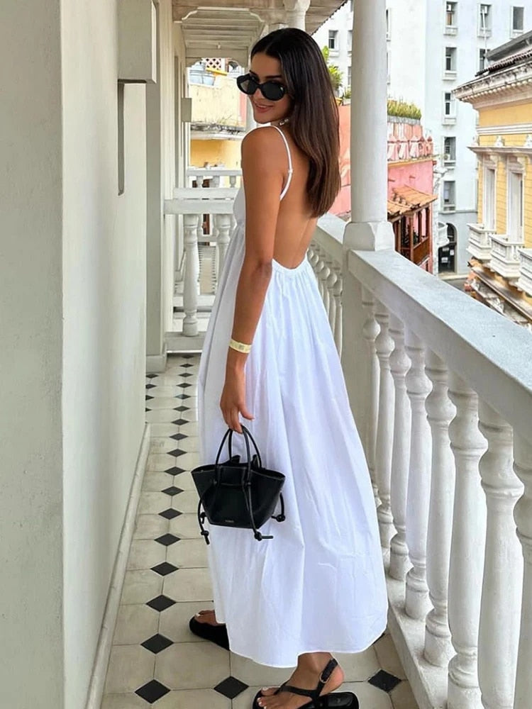 Elegant women's deep V-neck open back maxi dress, ideal for summer evenings or parties, with delicate spaghetti straps.
