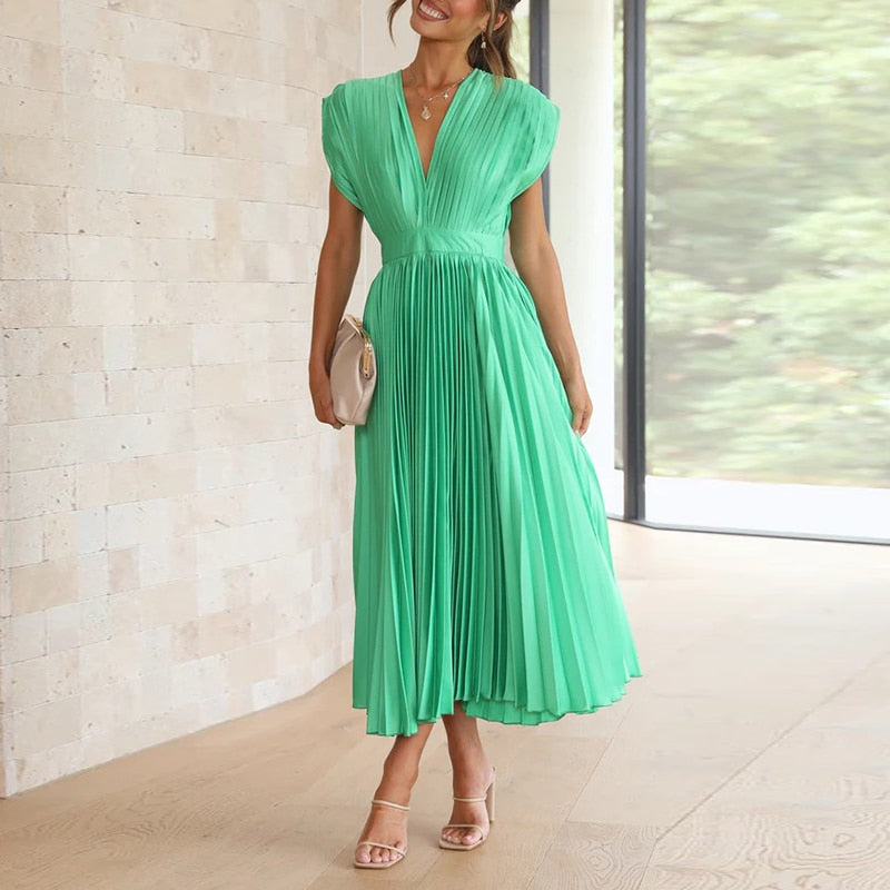 Full front view of a ladies' flowing V-neck maxi dress with delicate pleats, ideal for vacation outfits.