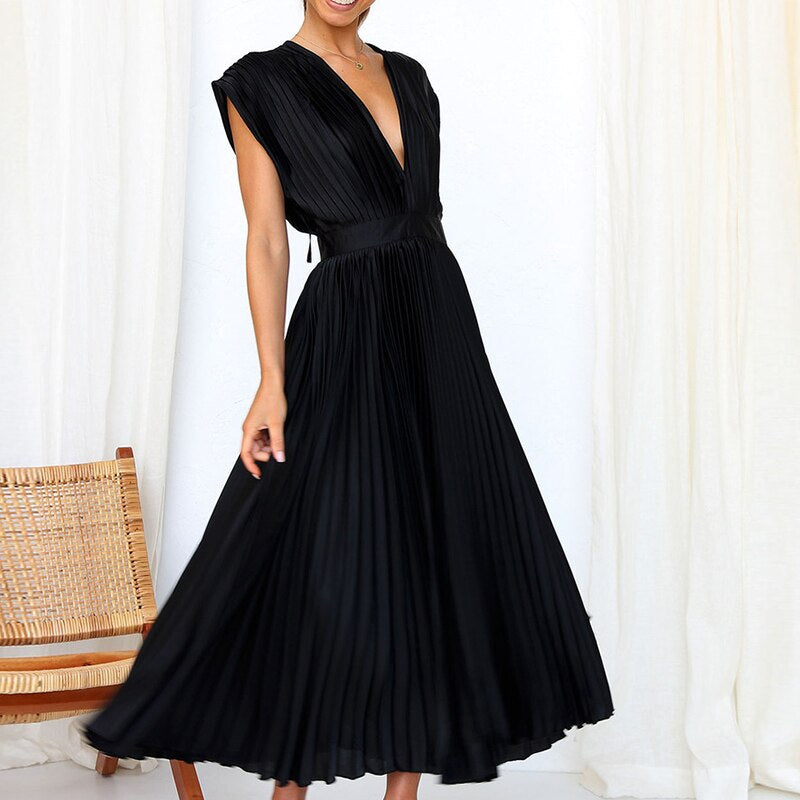 Women's stylish flowing pleated maxi dress in motion, highlighting its comfortable drape and design.