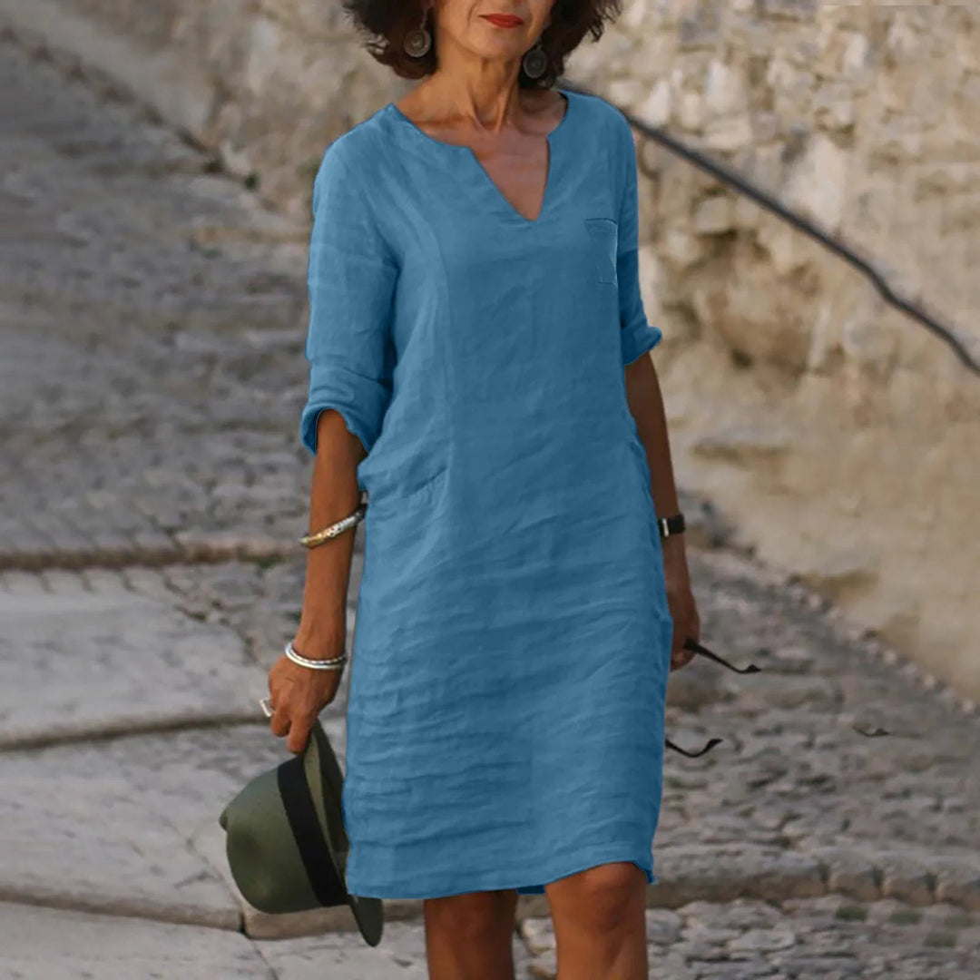 Elegant women's flowy summer midi dress in a vibrant color, perfect for casual outings.