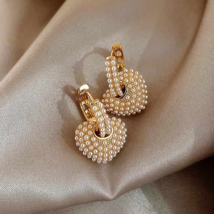 Stylish women's gold pearl drop earrings. Classic design, versatile elegant fashion jewelry.
