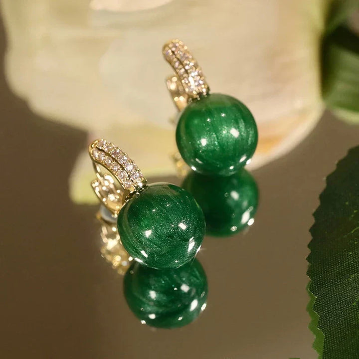 Stylish green and gold pearl drop earrings for women. Elegant fashion accessory, perfect to complete any sophisticated look.