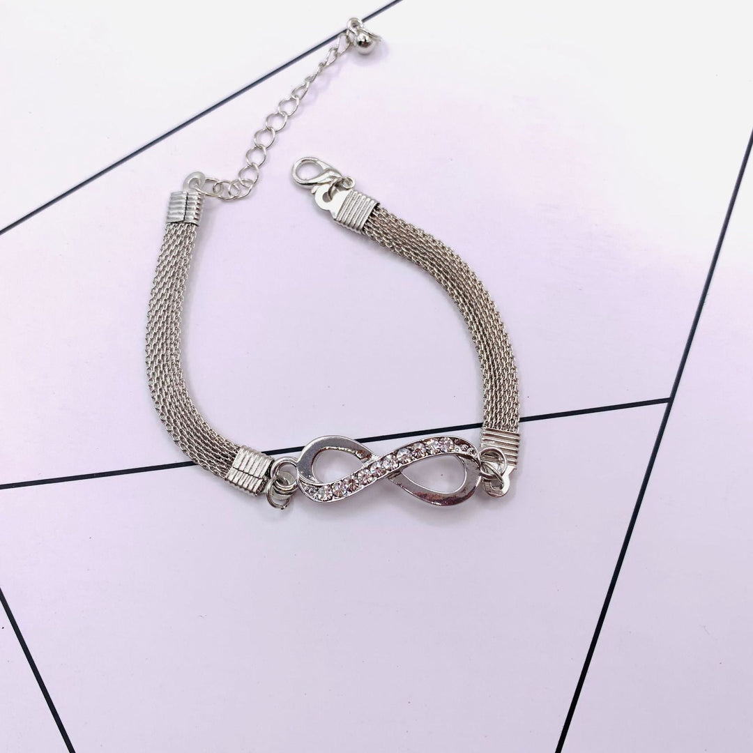 Stylish silver-tone infinity bracelet for women, featuring sparkling crystals. A sophisticated and elegant accessory.