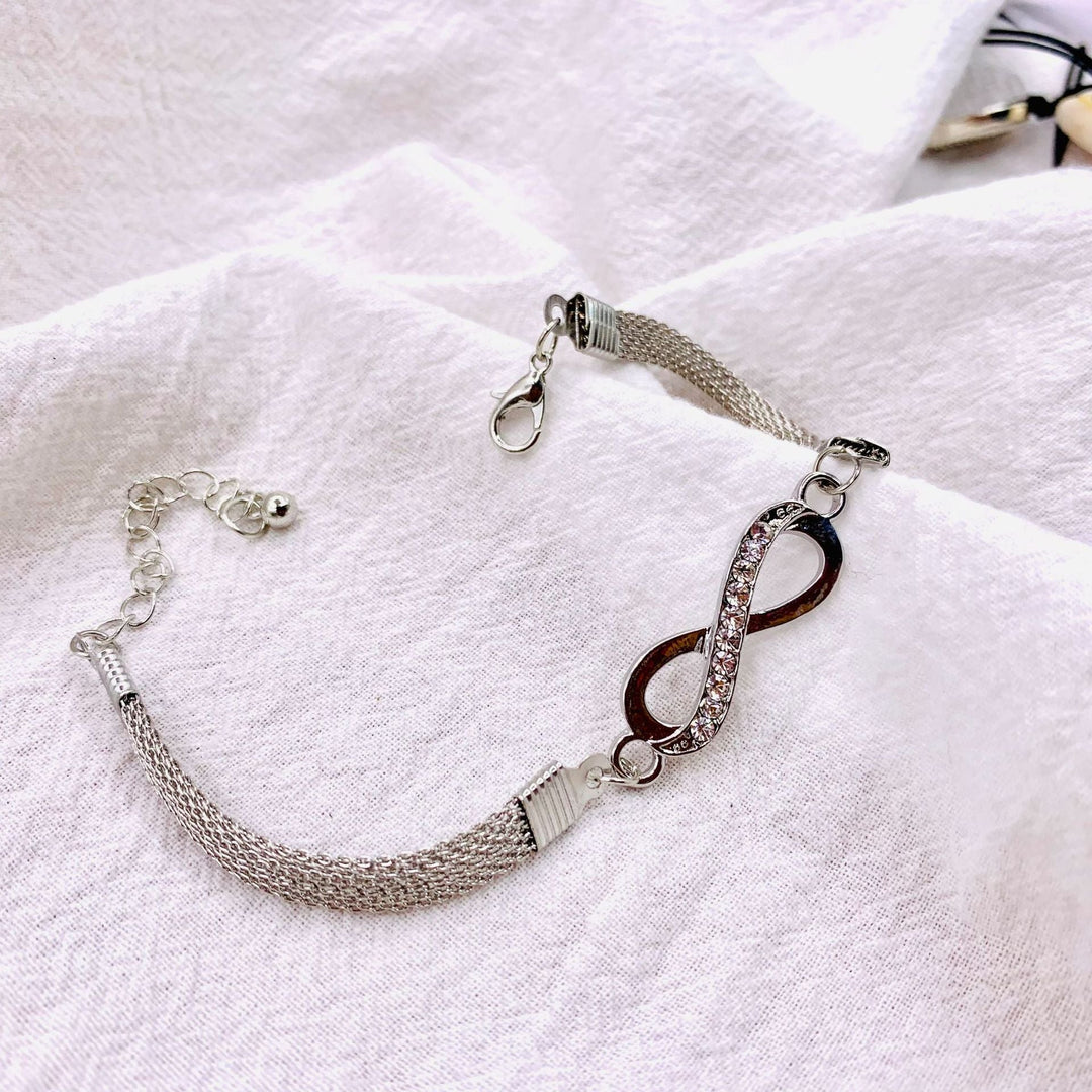 Delicate women's infinity bracelet with brilliant crystals, crafted in elegant silver. Adjustable for a perfect fit.