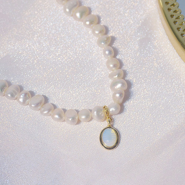 Elegant women's mini pearl charm necklace. Delicate short pearl necklace with a subtle, classic design.