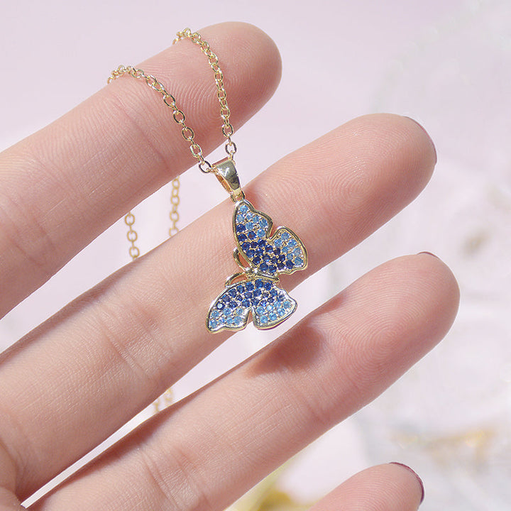 Close-up of a women's mini pearl charm necklace. Highlighting delicate short pearls and intricate charm detail.