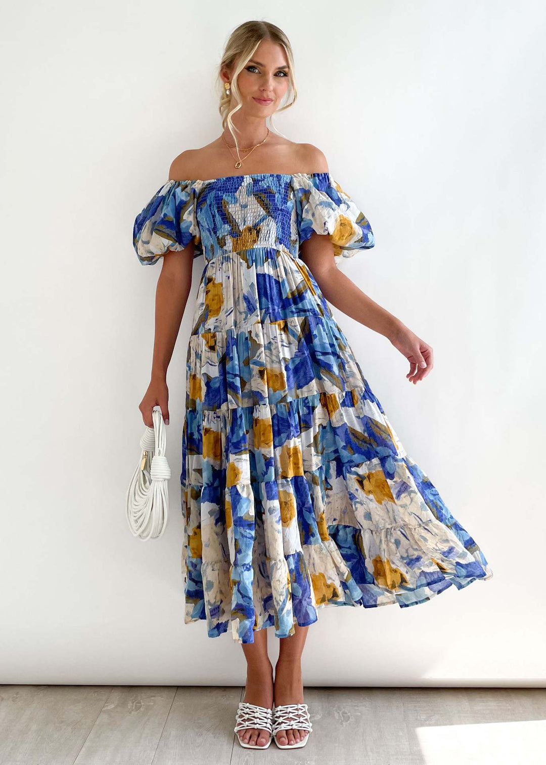 Elegant women's off-shoulder midi dress with flowing ruffles, perfect for summer parties or vacation.
