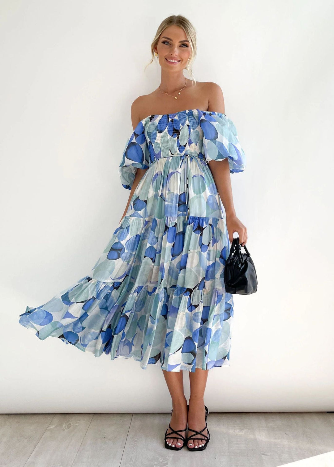 Beautiful women's off-shoulder midi dress featuring charming ruffles, a must-have flowing summer or party dress.