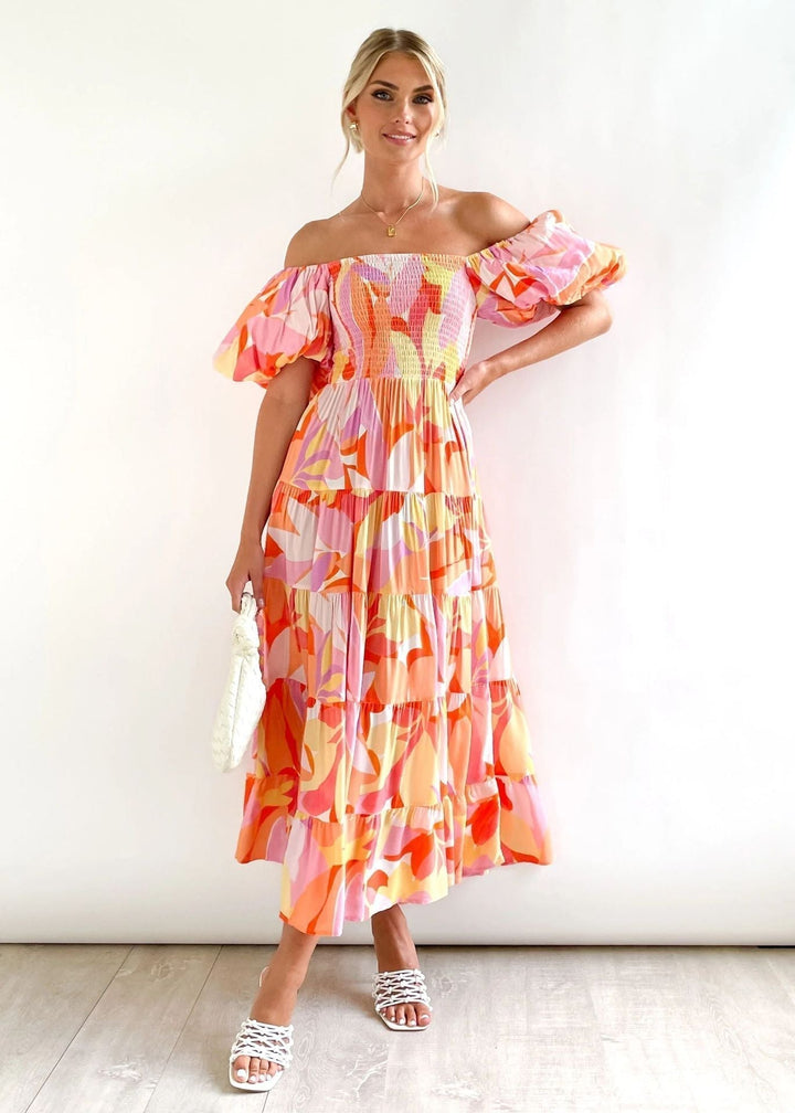 Women's elegant off-shoulder midi dress with ruffles. Flowing summer fashion, ideal for parties & vacations.