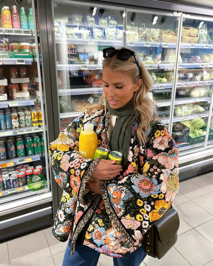 Trendy oversized women's padded jacket with a retro floral print, offering comfort and style for winter.