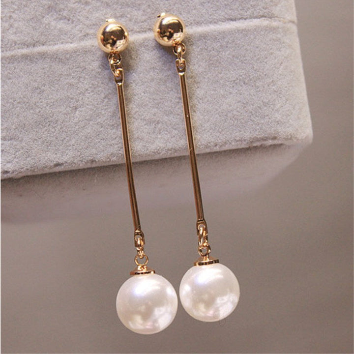 Luxurious pearl drop earrings for women. Close-up of elegant handcrafted silver-toned jewelry, perfect gift idea.