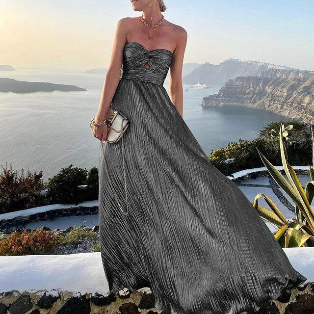 Elegant women's pink V-neck maxi summer dress with a stylish waist accent, perfect for vacation or parties.