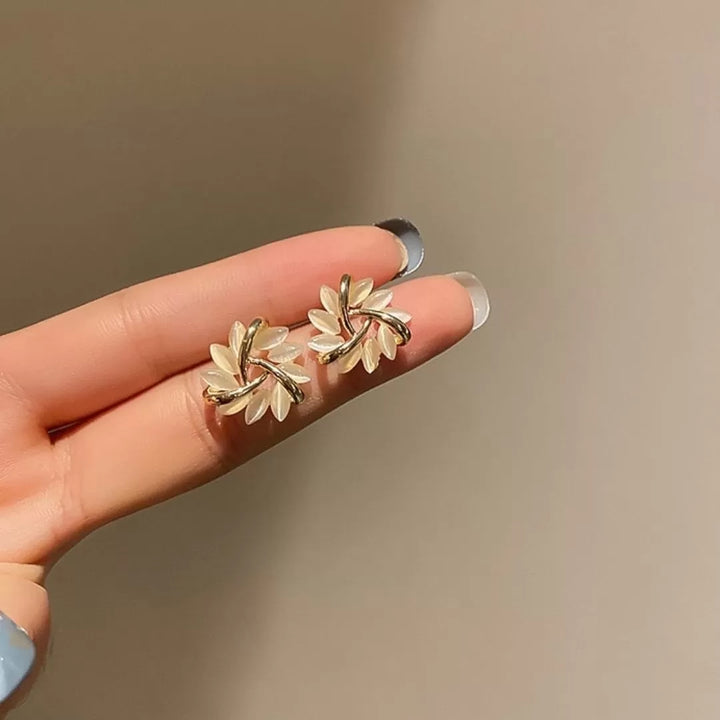 Model wearing delicate Sakura Blossom Opal stud earrings, highlighting their subtle sparkle and floral charm.