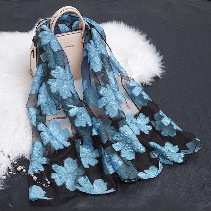 Luxurious women's floral silk scarf with unique cut-out detailing.