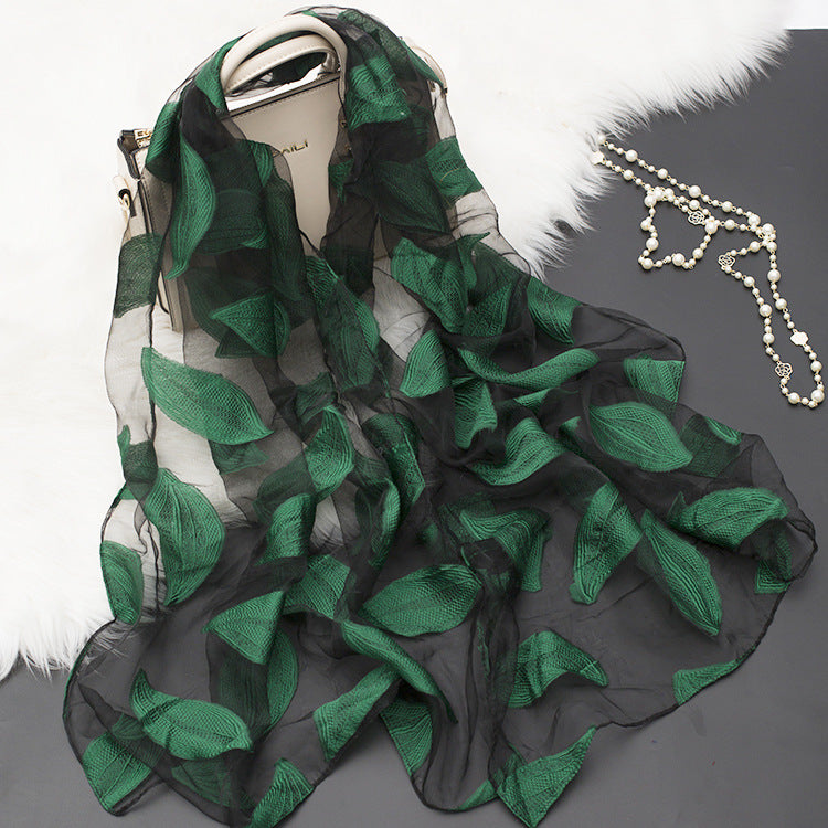 Beautiful women's silk floral scarf with intricate cut-out accents.