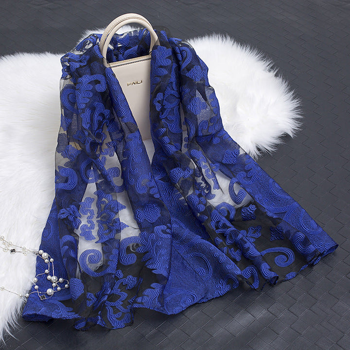 Versatile women's silk scarf featuring a trendy floral cut-out design.