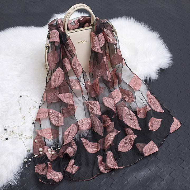 Luxurious floral cut-out silk scarf, a sophisticated fashion statement for women.