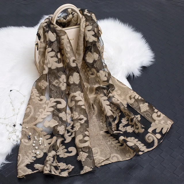 Versatile women's floral pattern silk scarf with a unique cut-out design.