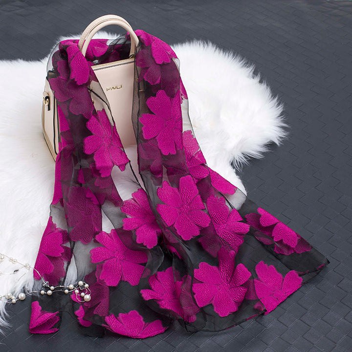 Fashionable women's floral silk scarf with a distinct cut-out design.