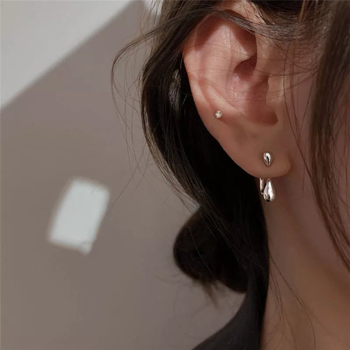 Classic gold-plated sterling silver teardrop stud earrings for women. Minimalist and elegant fashion accessory.