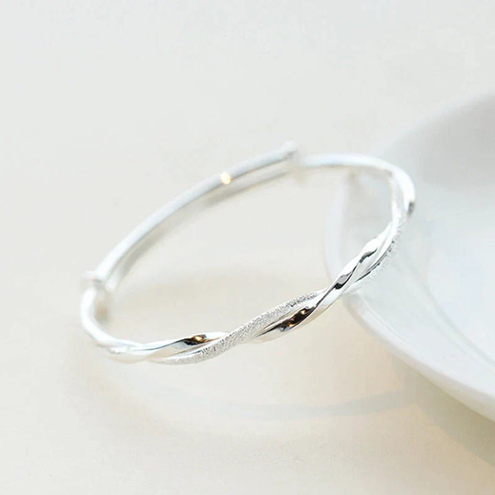 Close-up of elegant twisted sterling silver bracelet, a beautiful and classic gift for her.