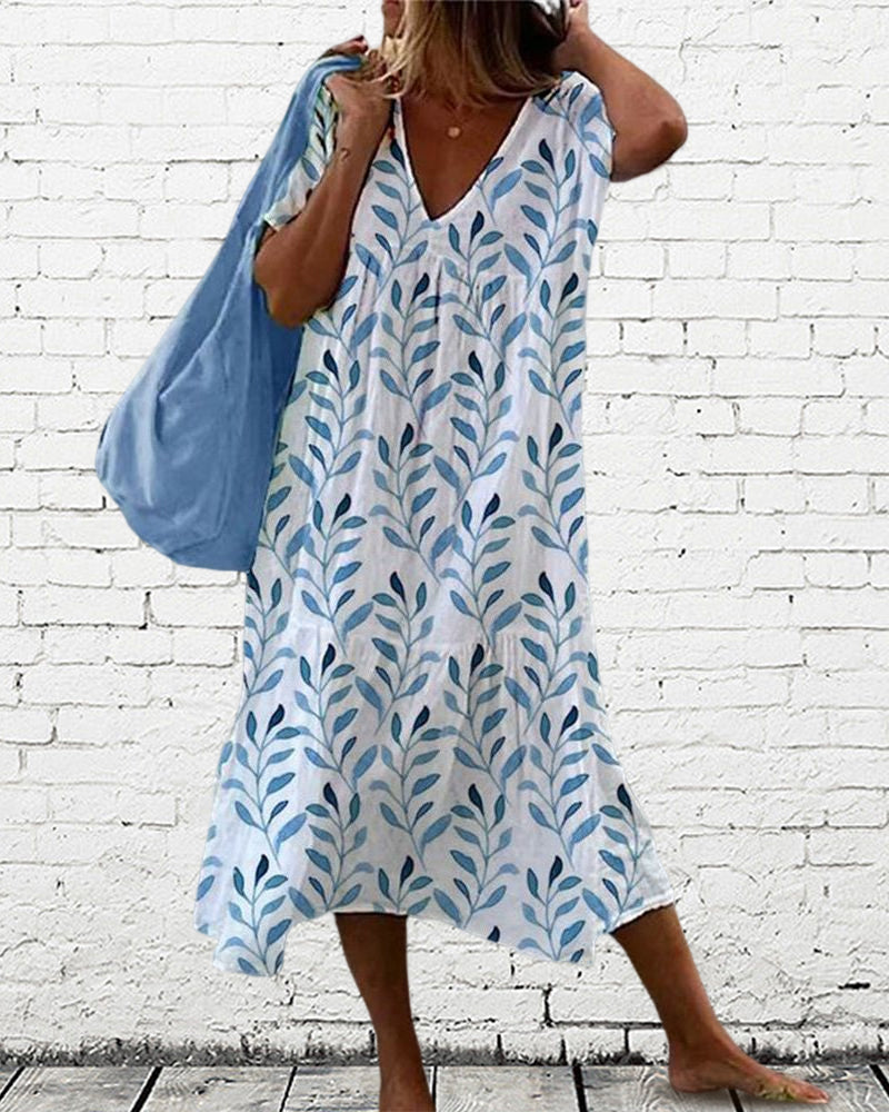 Trendy women's leaf print V-neck midi dress. Ideal for spring fashion, casual outings, or elegant vacation wear.