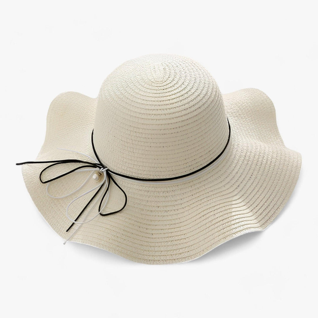 Women's fashionable beach hat with wide brim design and decorative bow, offering essential UV protection