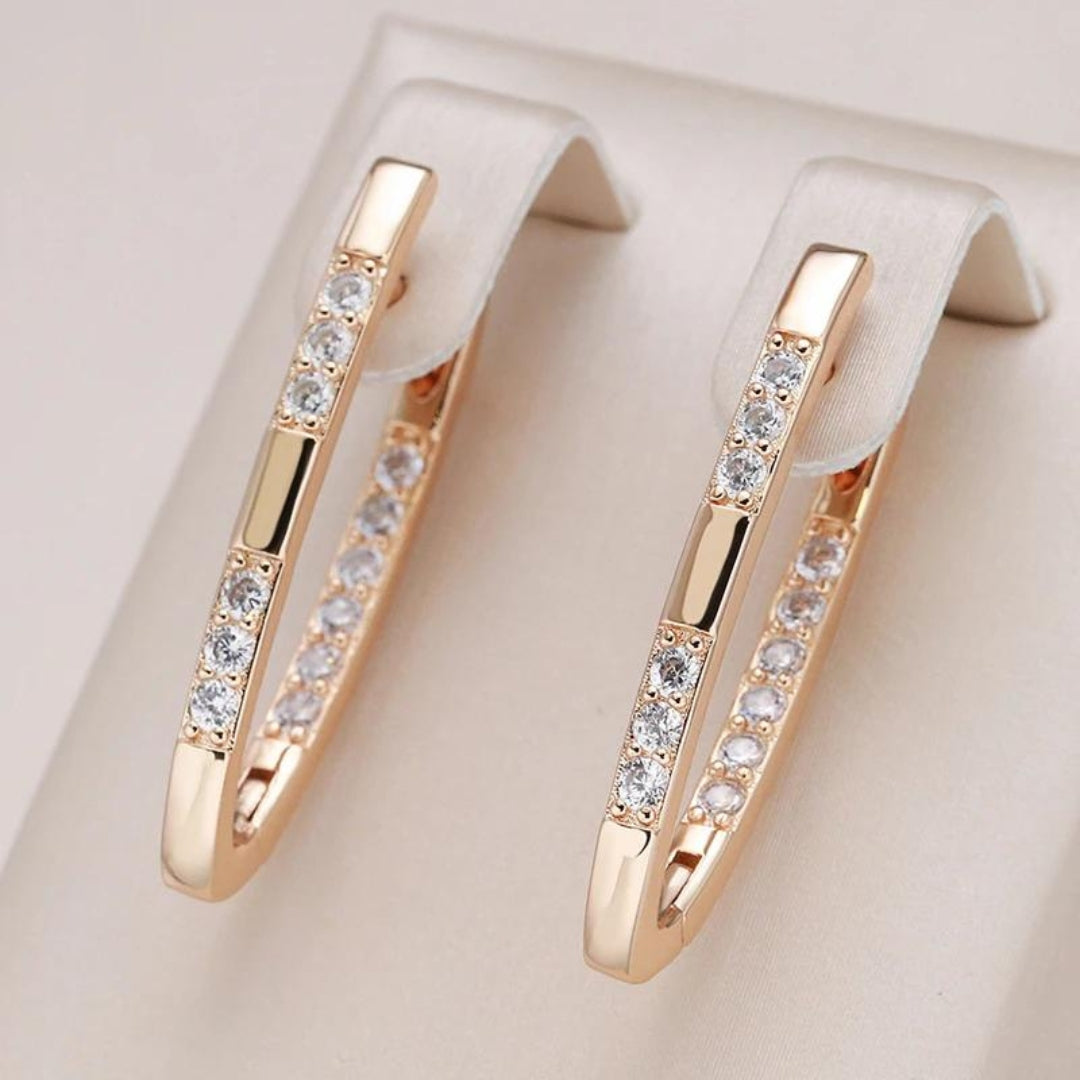 Elegant women's zirconia drop earrings, featuring sparkling gold & silver tones, a stylish fashion accessory.