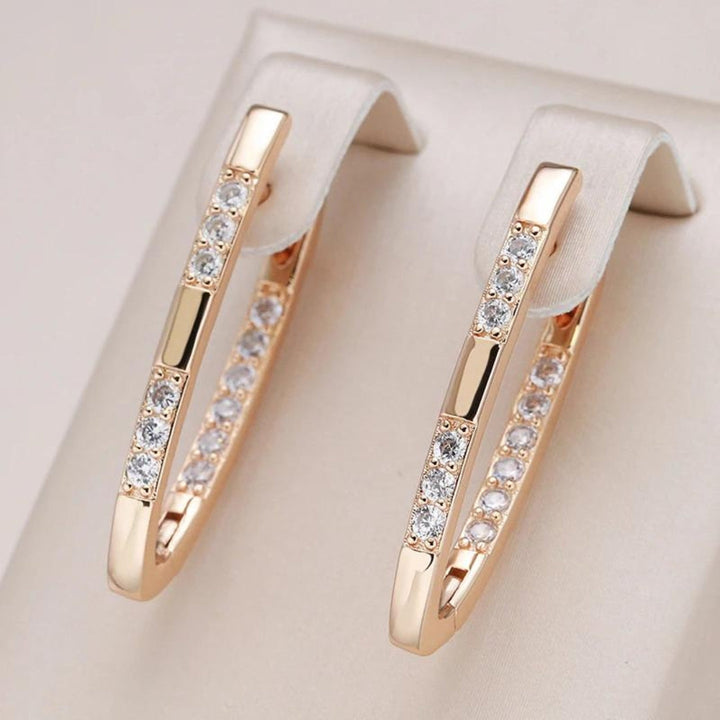 Elegant women's zirconia drop earrings, featuring sparkling gold & silver tones, a stylish fashion accessory.