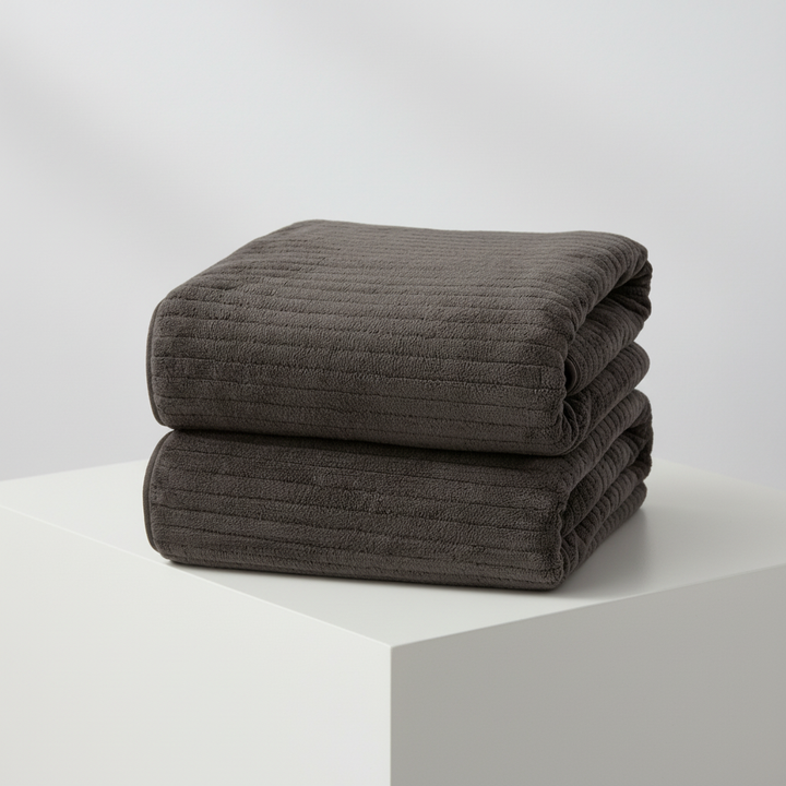 Unfolded extra large microfiber bath towel, white, illustrating its generous size and quick absorbent material.