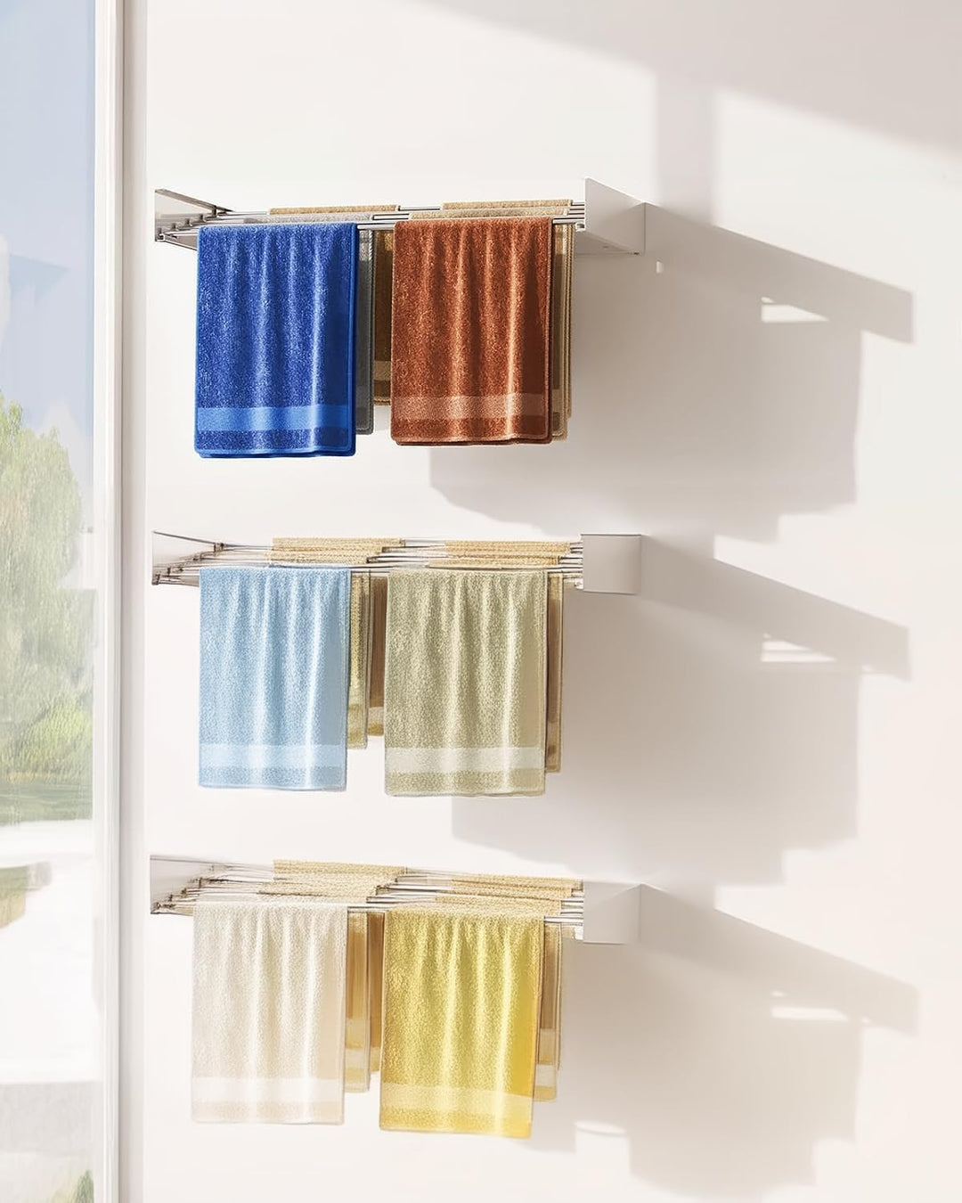 Extended wall-mounted foldable drying rack with towels and garments, demonstrating its full capacity