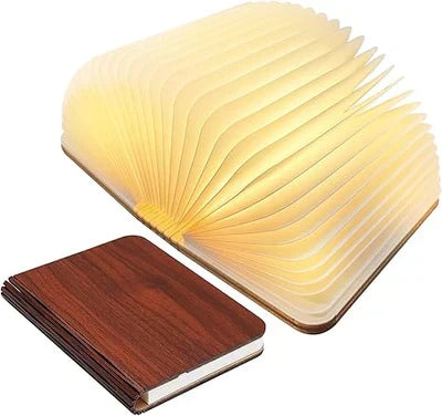 Folding LED book lamp, StoryGlow, providing cozy warm lighting. Ideal for bedside or desk.
