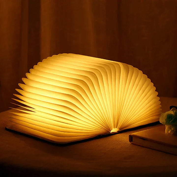 Versatile StoryGlow folding LED book lamp, rechargeable, warm light, ideal for home decor & gifts.
