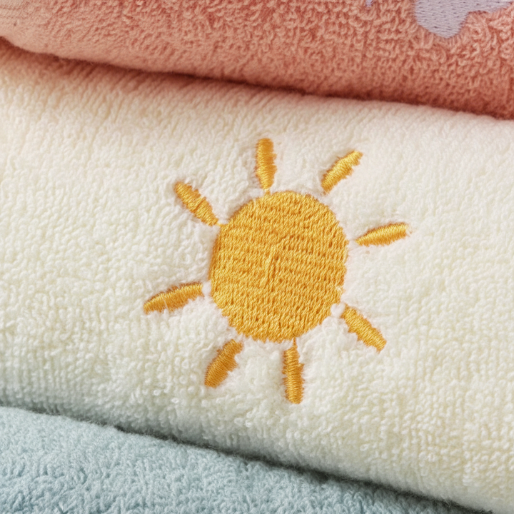 Close-up of a stack of soft, absorbent children's cotton washcloths in various colors