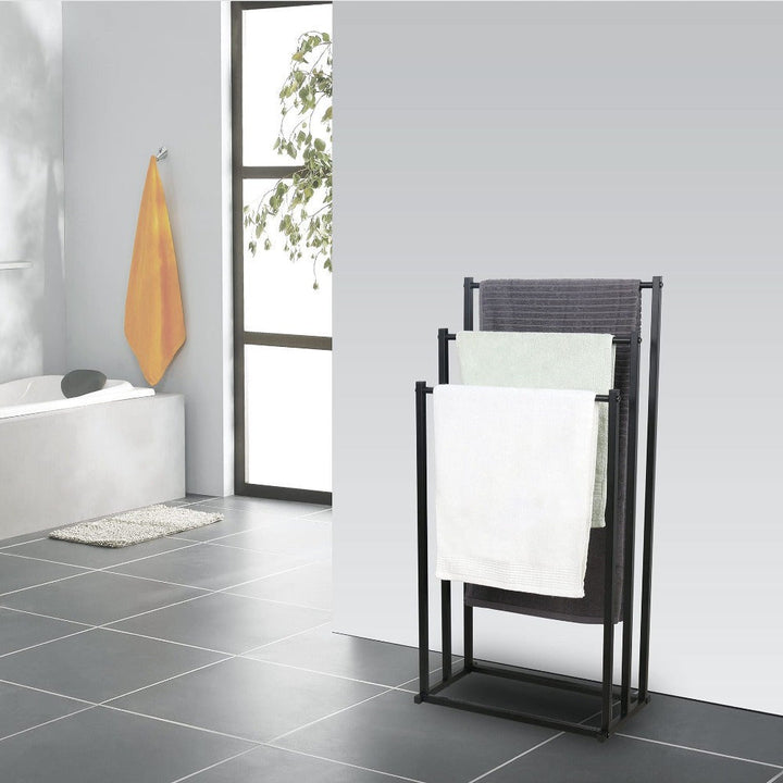 Bathroom interior with a freestanding steel towel rack, NeatRack, holding multiple towels neatly