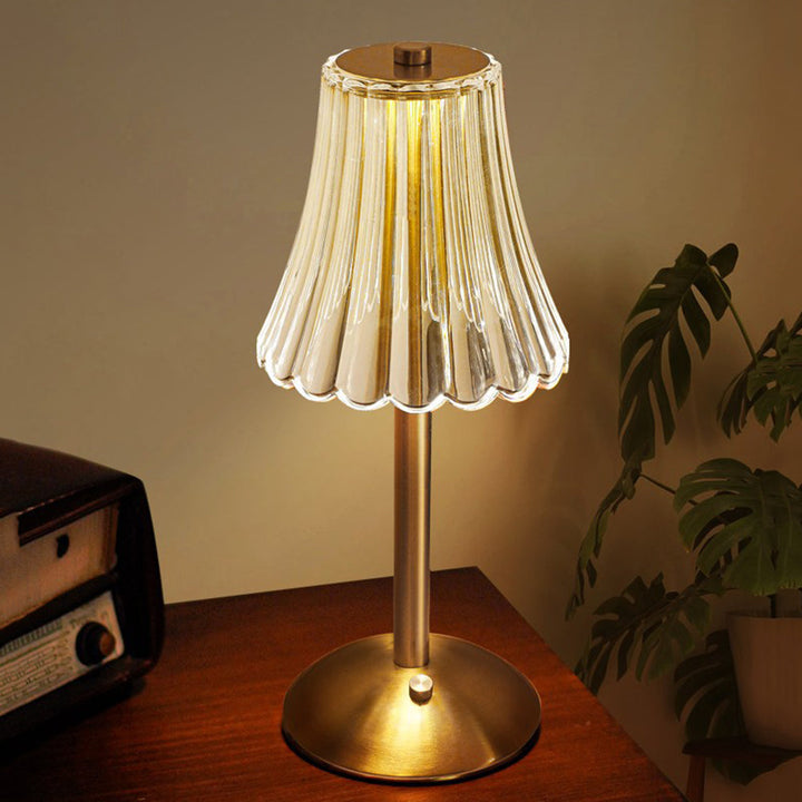 Aurora Luxe golden crystal table lam on a desk, illuminating the space with a warm glow