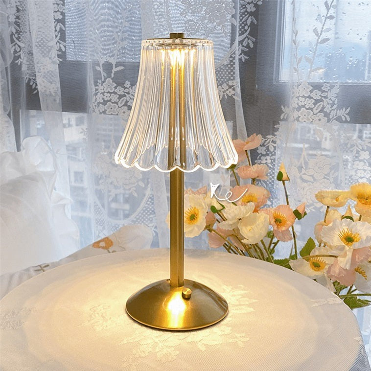 Stylish golden crystal table lamp on a nightstand, offering convenient touch control lighting