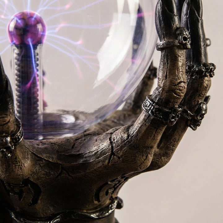 Decorative gothic skeletal hand table lamp with mesmerizing purple plasma light, perfect for mood lighting.