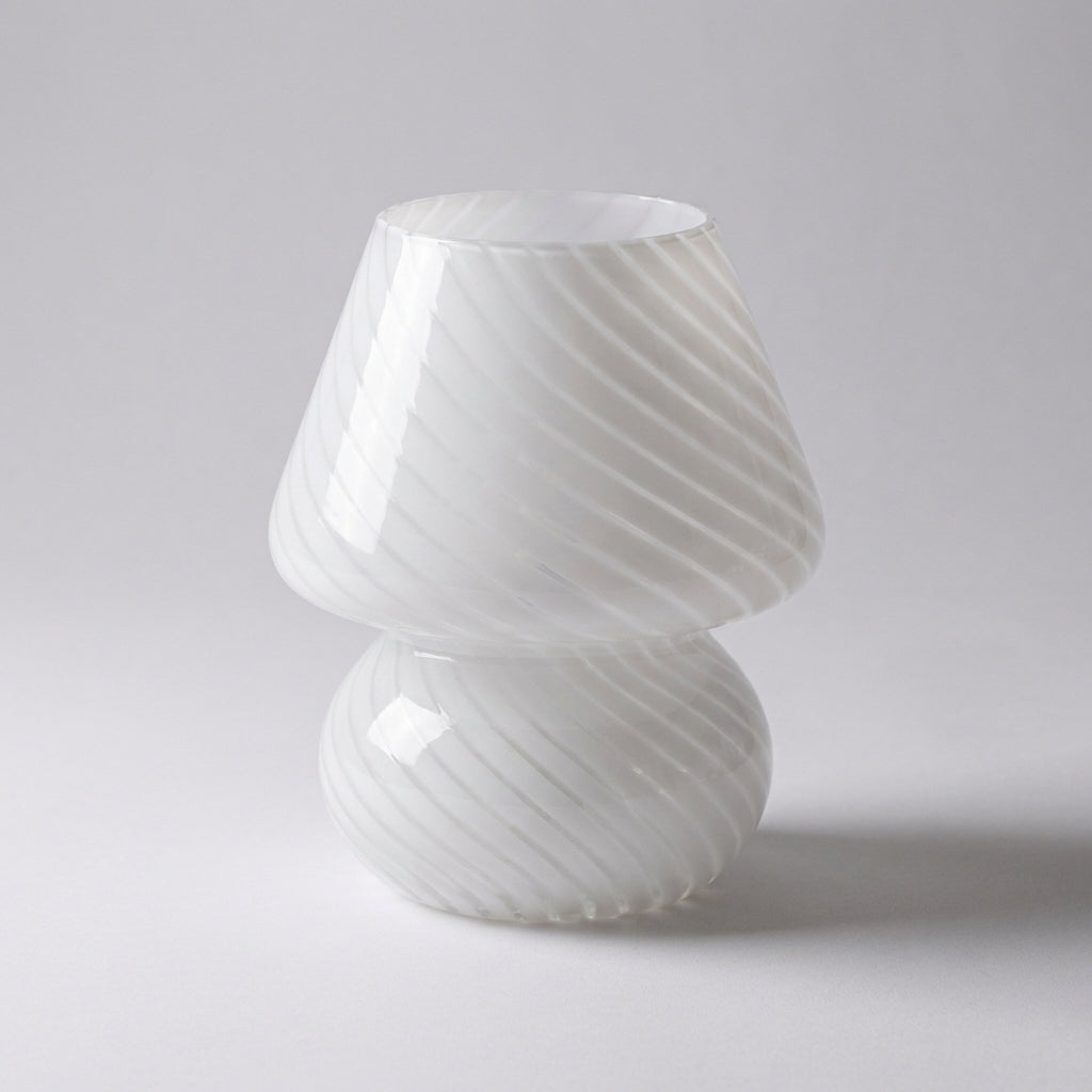 Tabletop view of a stylish Vellumo accent lamp, handcrafted with premium Murano glass for ambient lighting