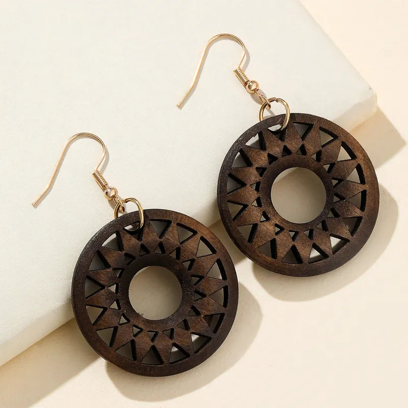 Organic retro carved wooden dangle earrings, unique handmade fashion accessory for women's style.