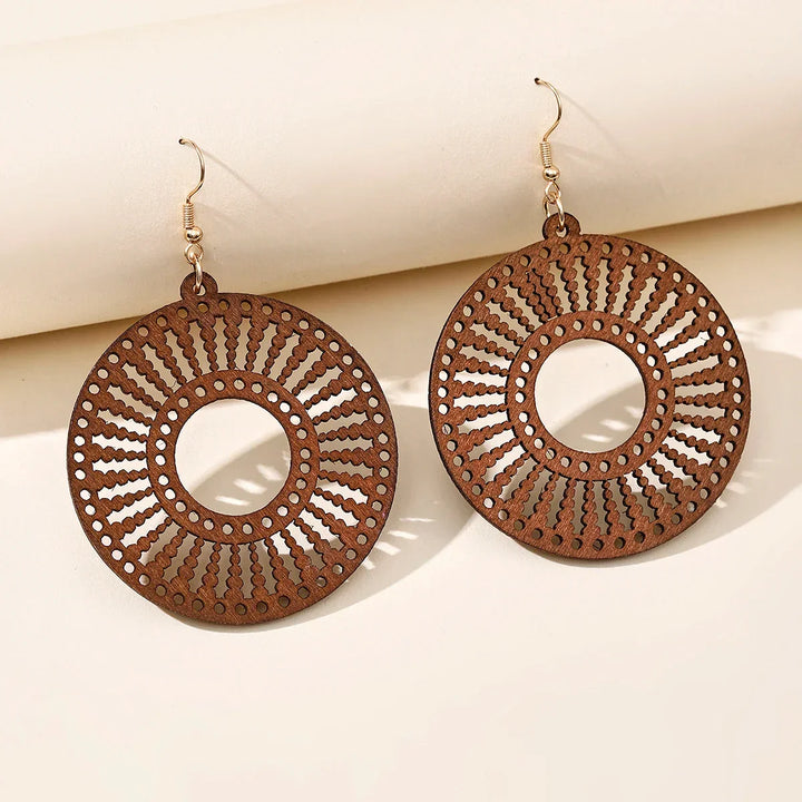 Women's vintage style carved wooden dangle earrings, a unique retro jewelry piece and fashion accessory.
