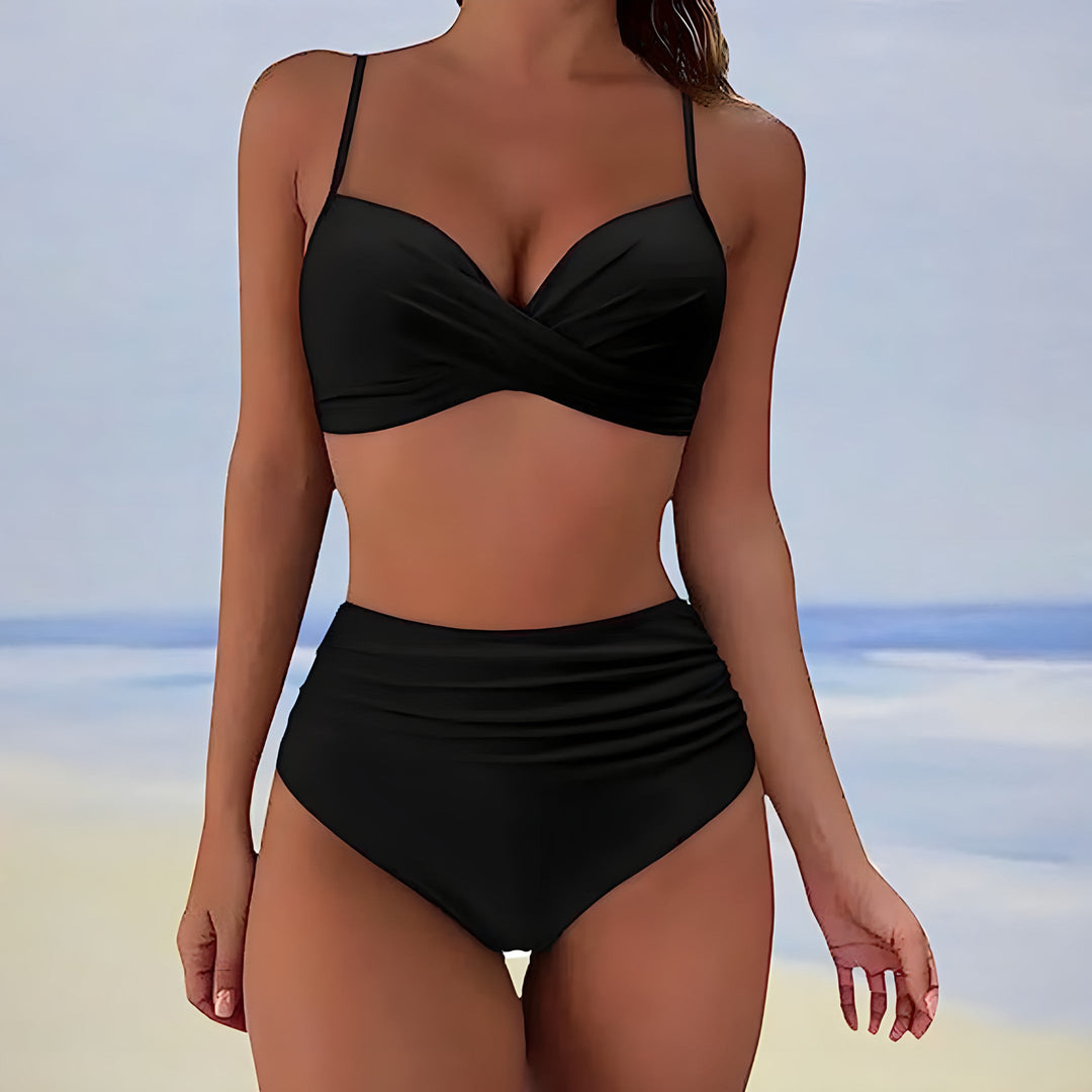 Woman posing in high-waisted bikini at sunset, stylish and comfortable vacation swimwear