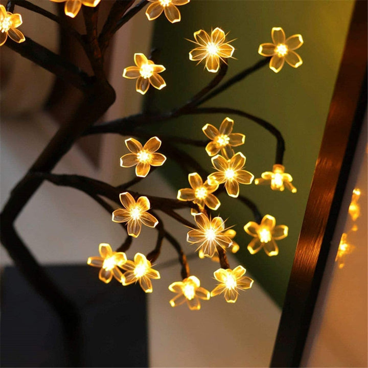 Decorative cherry blossom tree lamp, USB powered, ideal for creating a cozy home decor atmosphere.