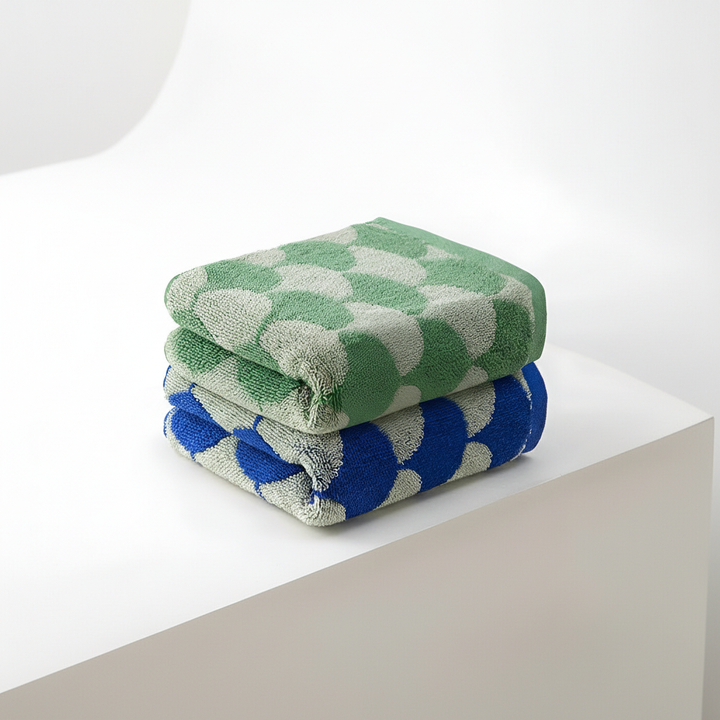 Close-up of a Jacquard cotton hand towel, showcasing its detailed fan design and plush, absorbent texture.
