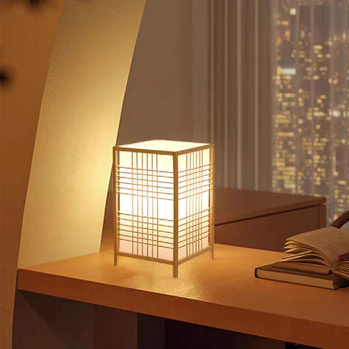 Modern Japanese style bedside lamp with natural wood & rice paper shade, creating warm ambient light.